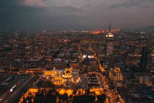 pexels-photo-6943642-6943642 A breathtaking aerial view of Mexico City at night featuring the illuminated skyline and Palacio de Bellas Artes.
